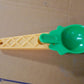 Kitchen setup featuring plastic ice cream scooper with trigger