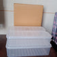 Three plastic fridge storage containers displayed on a wooden surface, highlighting their clear material.
