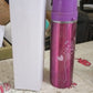 Stainless steel water bottle on a modern desk, promoting healthy office hydration.