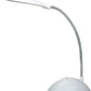 Portable LED reading light illuminating a book and workspace.