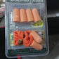 Comfortable soft foam earplugs displayed on a wooden table.