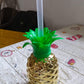 Isolated view of the plastic pineapple cup with straw on a plain background.