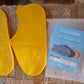Waterproof silicone shoe covers worn over shoes in an outdoor setting.