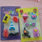 Variety of colorful 3D erasers displayed together, emphasizing the mixed design aspect.