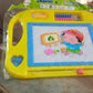 A child's hand demonstrating the easy-erase function of the magic sketch slate by sliding the bar.