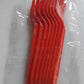 Close-up focus on red plastic disposable forks for party use