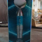 The compact facial beauty device in a woman's hand, ready for use.