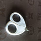 Close-up of baby safety nail cutter scissors showing circular blade