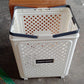 Folded state of large plastic laundry basket with wheels for compact storage