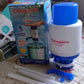 Versatile manual water hand press pump suitable for dispensing water from large bottles in home or office.