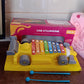 Close-up of the precisely tuned, colorful xylophone bars on the car-shaped musical toy.