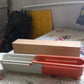 Another angle of the grey plastic telescopic sink storage rack, highlighting its sturdy design.