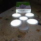 Solar Camping Light placed on an outdoor surface, ready for charging.