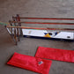 Installed wall-mounted folding stainless steel drying rack holding clothes