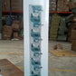 The versatile wall mounted mop holder shown with various cleaning and garden tools.