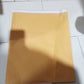Several brown kraft envelopes lying flat on a table, showcasing their texture.