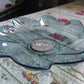 An overhead view of a single flower shaped kids plastic plate, showcasing its unique and attractive design.