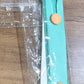 Teal green phone finger holder used to hang smartphone on hook