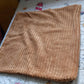Textured corduroy decorative pillow cover styled on an armchair in a farmhouse-inspired room.