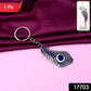 Close view of crystal adorned peacock feather keychain in metal