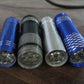 The mini LED flashlight illuminating a dark indoor space, demonstrating its bright beam.