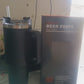 Angled view of stainless steel travel mug with lid and handle visible