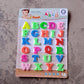 Magnetic letters neatly stored in a clear container, ready for travel.