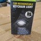 Side view of the rechargeable keychain flashlight with its magnetic base.