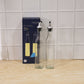 Packaged set of two transparent glass oil dispensers with lids
