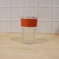 Hand holding glass tumbler with lid, perfect for daily hydration