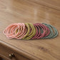 Collection of elastic hair bands in neutral shades, lightweight for daily wear