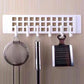 Practical plastic hanger hook mounted on a wooden wardrobe door, ready for use.