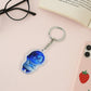 Blue cartoon acrylic keychain charm attached to metal ring