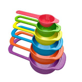 Set of 6 colorful plastic measuring spoons in various sizes, neatly arranged.