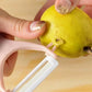 The versatile vegetable peeler alongside a pile of freshly peeled veggies.