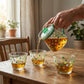 Glass tea pot and cups arranged beautifully for tea serving