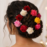 A collection of colourful flower hair pins in mixed hues, laid out for display.
