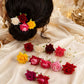 Detailed view of a single bright flower hair pin, showcasing its intricate design.
