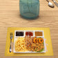 Divided plastic meal tray with raised edges preventing spills.