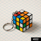 Hand holding a compact Mini Magic Cube Puzzle keychain, ready for play.