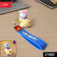 Close-up of cartoon cat riding toy car silicone keychain