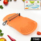 Cut 'n' Wash cutting board showing detachable knife and water draining through integrated strainer