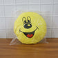 Smiley face plush pillow cushion in a colorful kids’ room setting