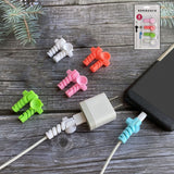 White cable protector securing a charging cable with suction end, preventing bends.