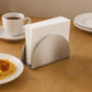 Front view of stainless steel half-moon napkin holder