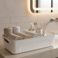 Side view of stackable white plastic storage baskets